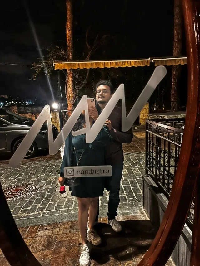Akanksha and Kushal in a mirror selfie on their first date, with a rose