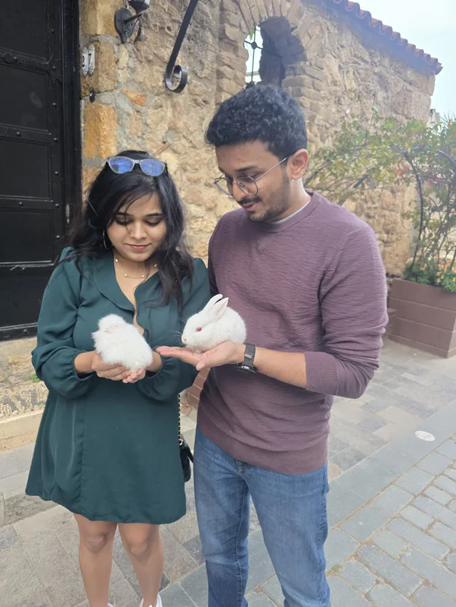 Akanksha and Kushal holding rabbits in Antalya